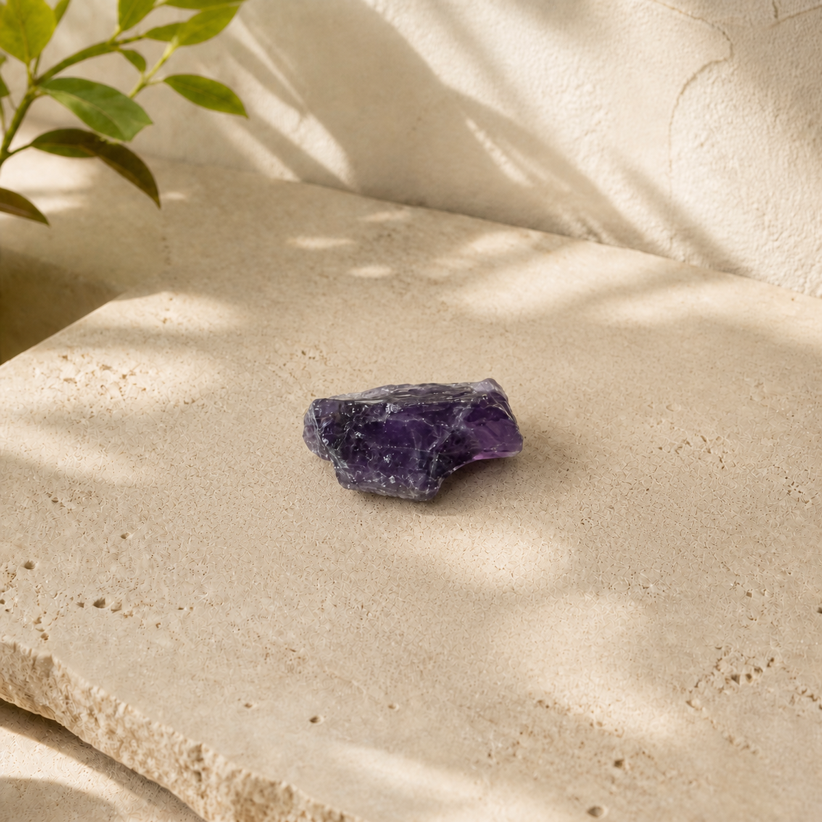 Single raw amethyst stone displayed on a pale limestone slab
