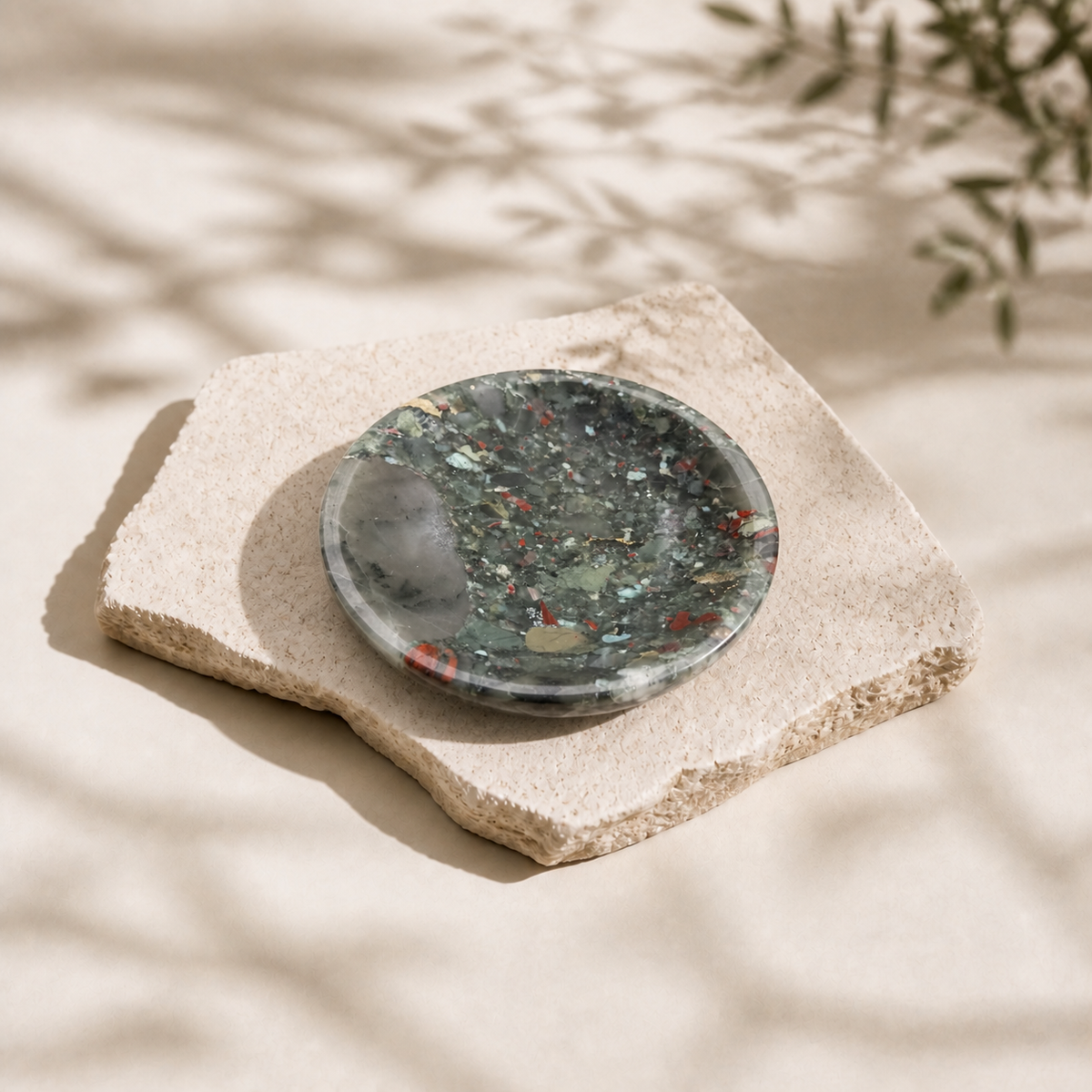African Bloodstone rounded bowl on a pale stone slab