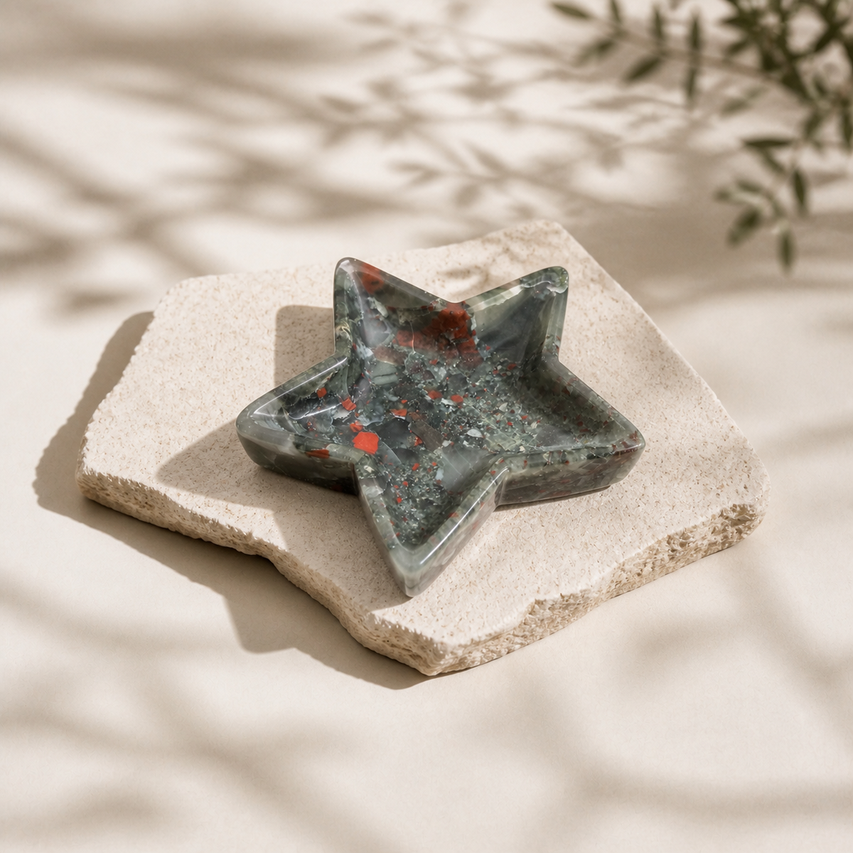 African Bloodstone star-shaped bowl on a pale stone slab