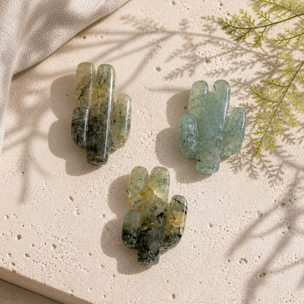 Three polished Prehnite cactus crystal carvings on limestone