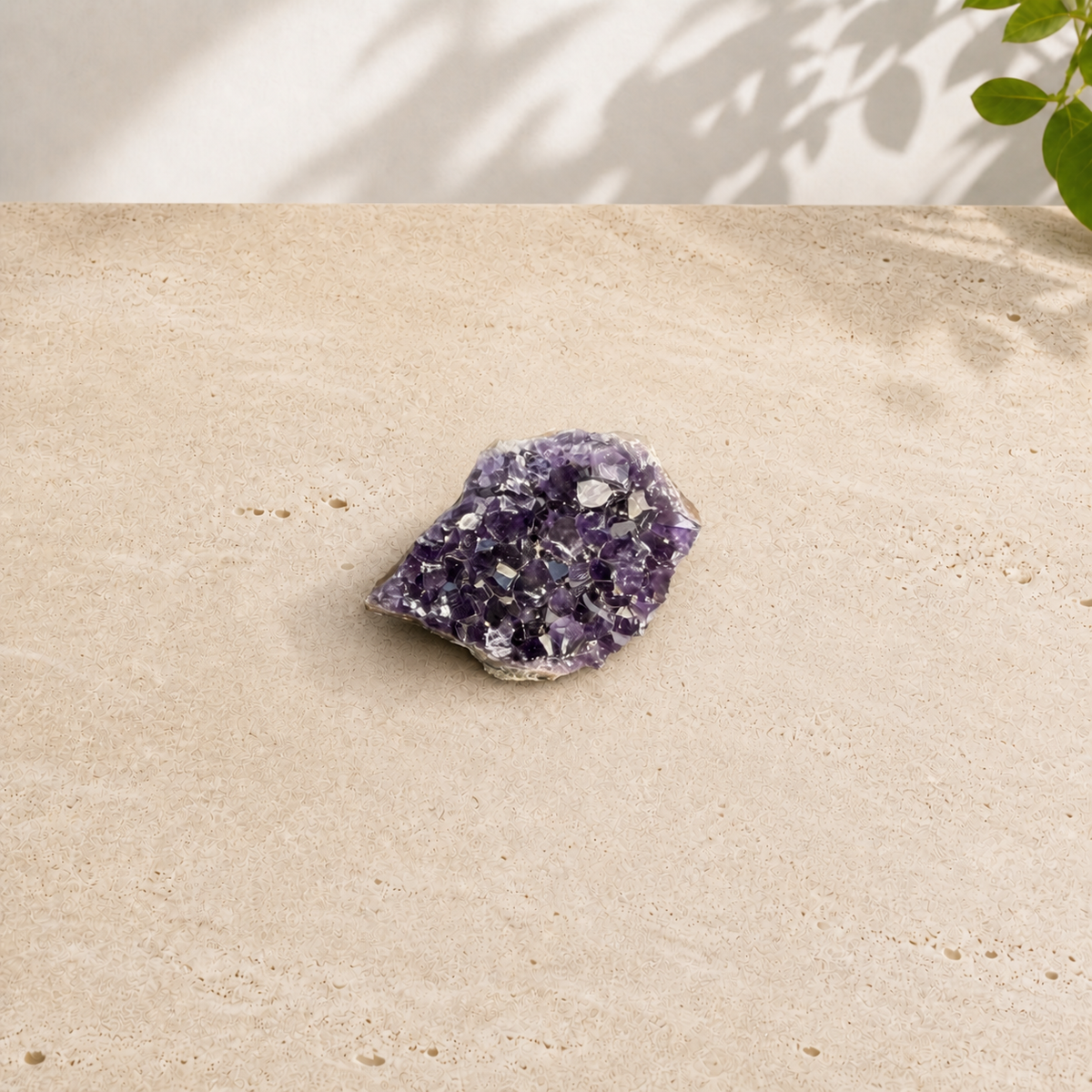 A single dark purple amethyst cluster with naturally formed crystal points and a rough mineral base.