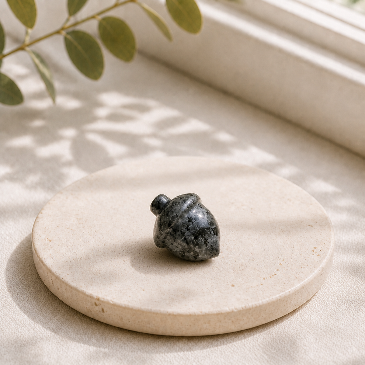 Larvikite polished crystal acorn carving