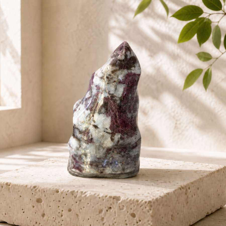 Pink Tourmaline in Quartz flame carving on a cream travertine block
