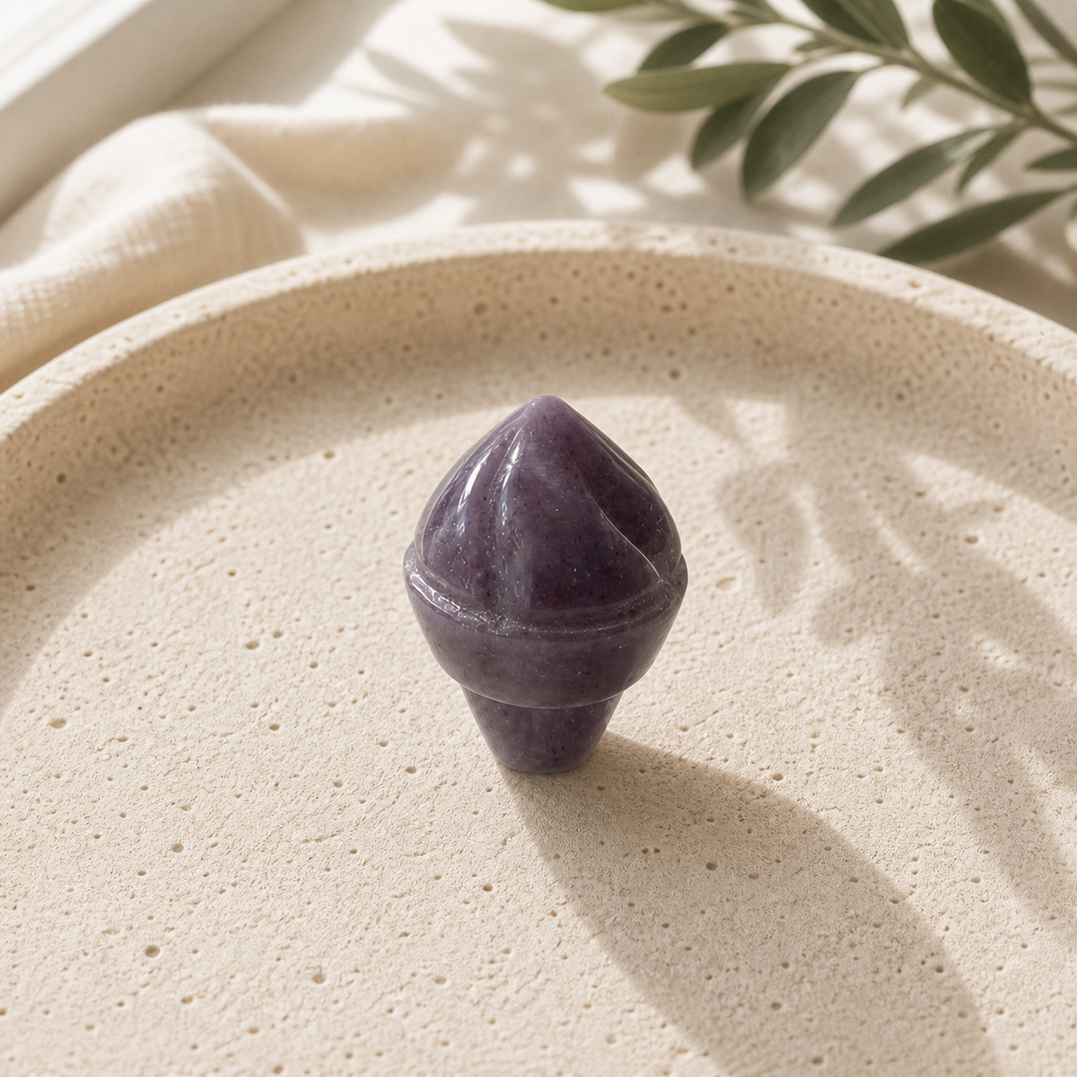 Purple Fluorite crystal ice-cream carving standing on a cream travertine plate
